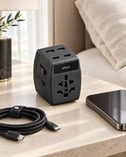 ALTAIR 65 W travel adaptor plugged in at a hotel
